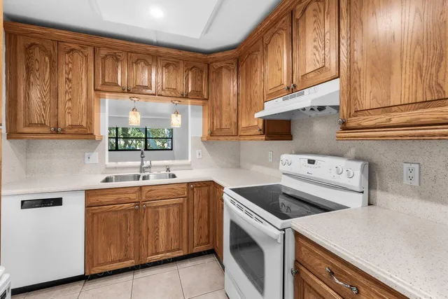 a kitchen with a sink cabinets and window