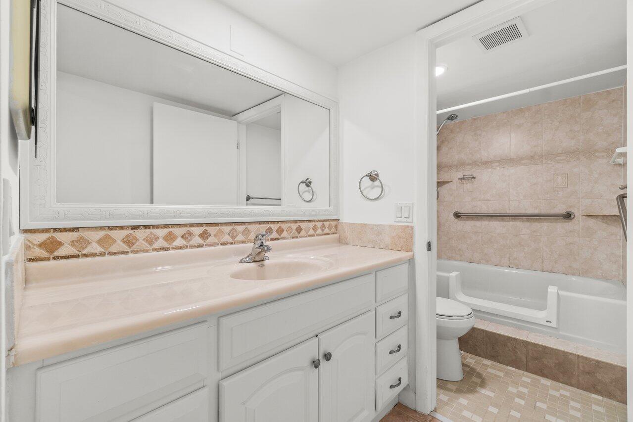 3014 Southwest 21st Terrace, Unit 352B Delray Beach, FL 33445 - Photo 18 of 26 a bathroom with a sink and a mirror