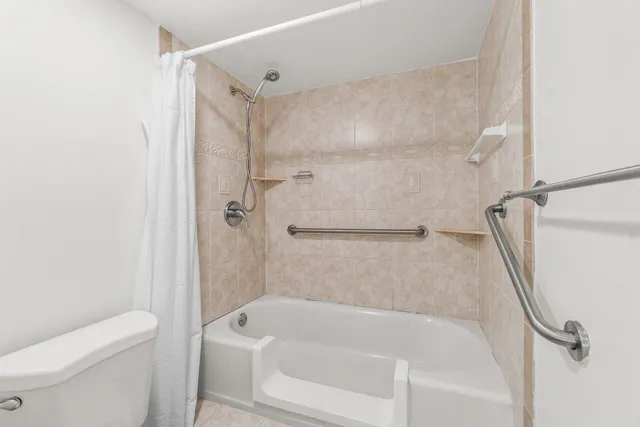 a bathroom with a bathtub a toilet and a shower