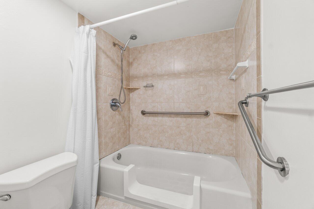 3014 Southwest 21st Terrace, Unit 352B Delray Beach, FL 33445 - Photo 19 of 26 a bathroom with a bathtub a toilet and a shower