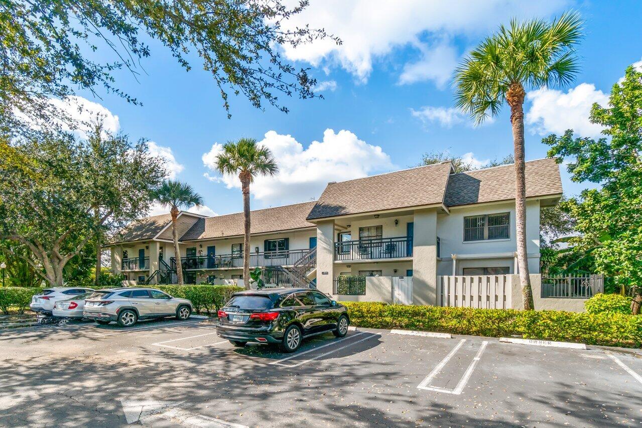 3014 Southwest 21st Terrace, Unit 352B Delray Beach, FL 33445 - Photo 2 of 26 a car parked in front of a house