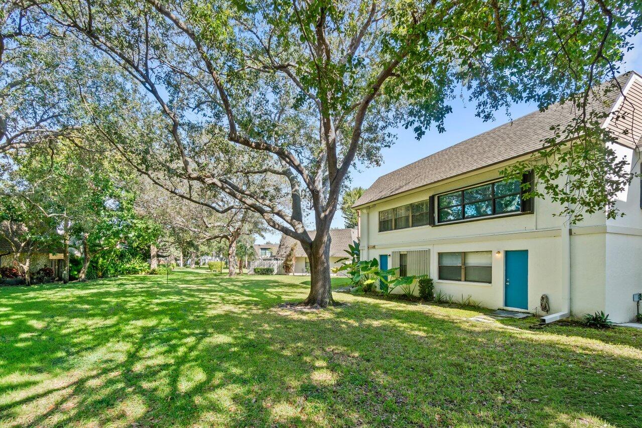 3014 Southwest 21st Terrace, Unit 352B Delray Beach, FL 33445 - Photo 24 of 26 a front view of a house with a garden