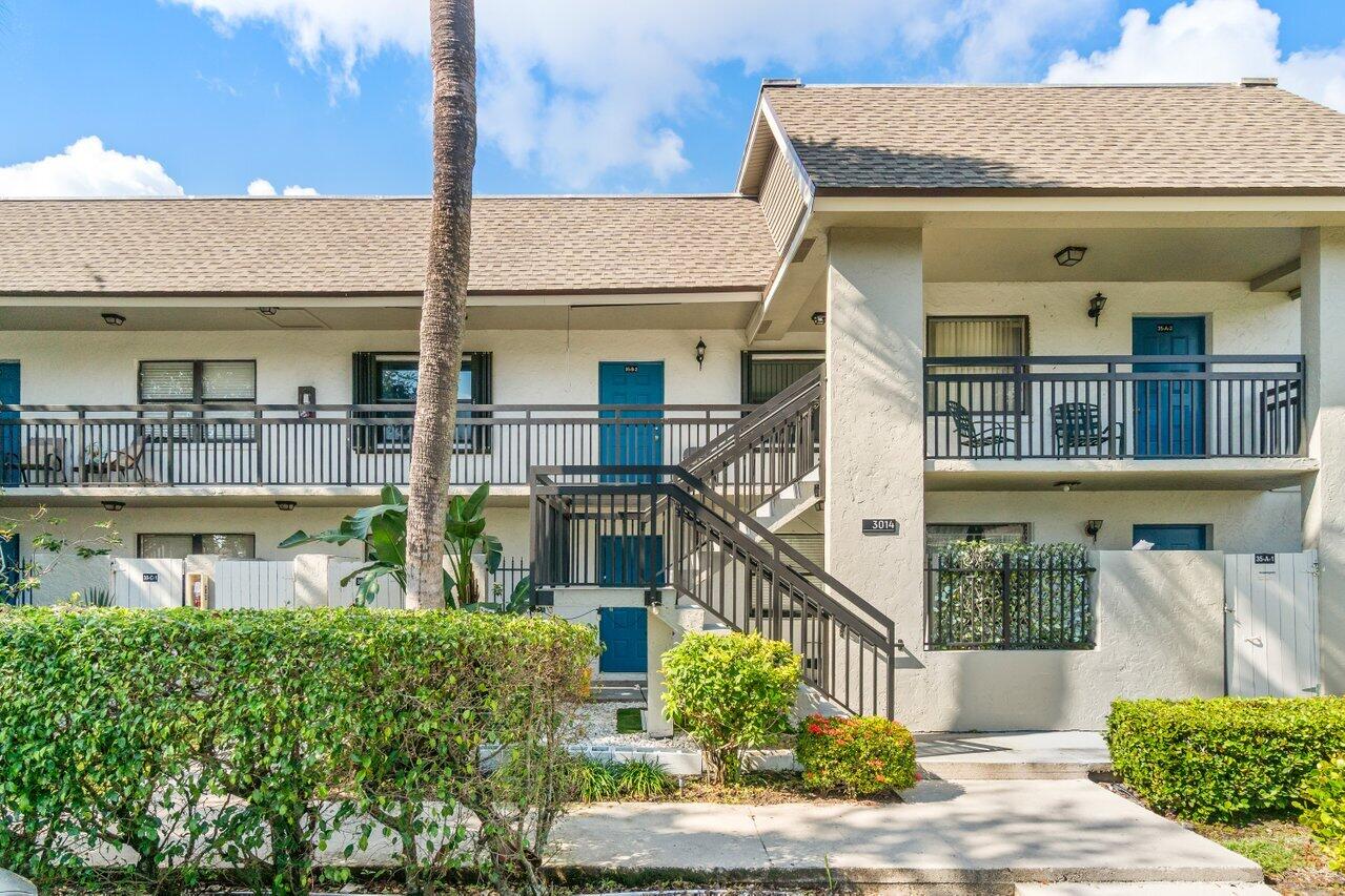 3014 Southwest 21st Terrace, Unit 352B Delray Beach, FL 33445 - Photo 3 of 26 a front view of a building with garden