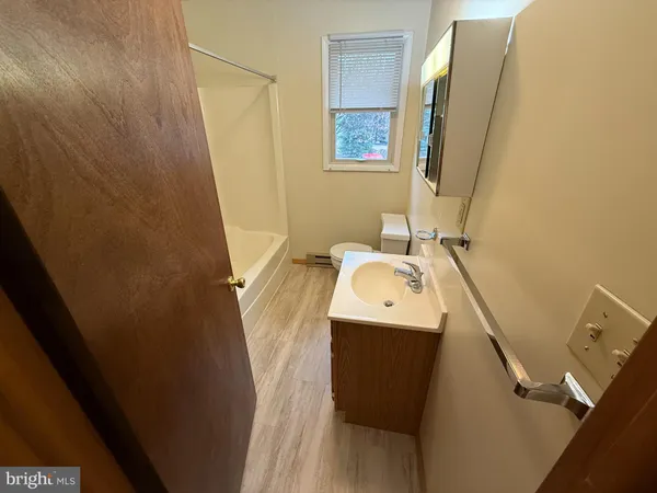 a bathroom with a sink mirror and vanity