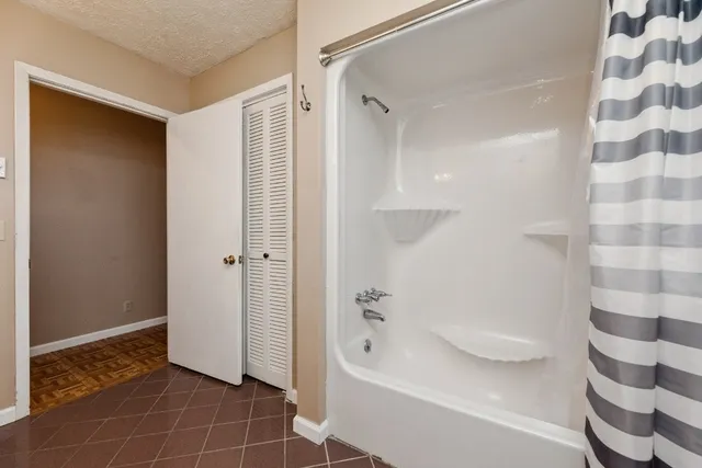 a bathroom with a bathtub and a shower