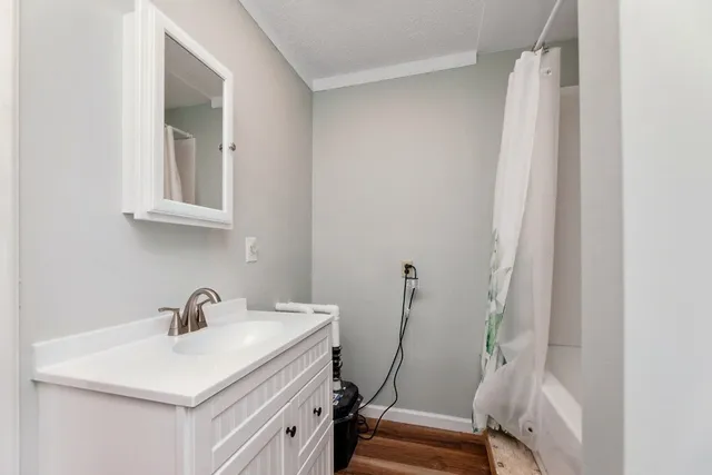 a bathroom with a sink a toilet and a mirror