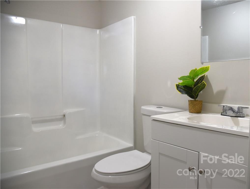458 Kimmon Road Harmony, NC 28634 - Photo 14 of 23 a bathroom with a sink a toilet and shower