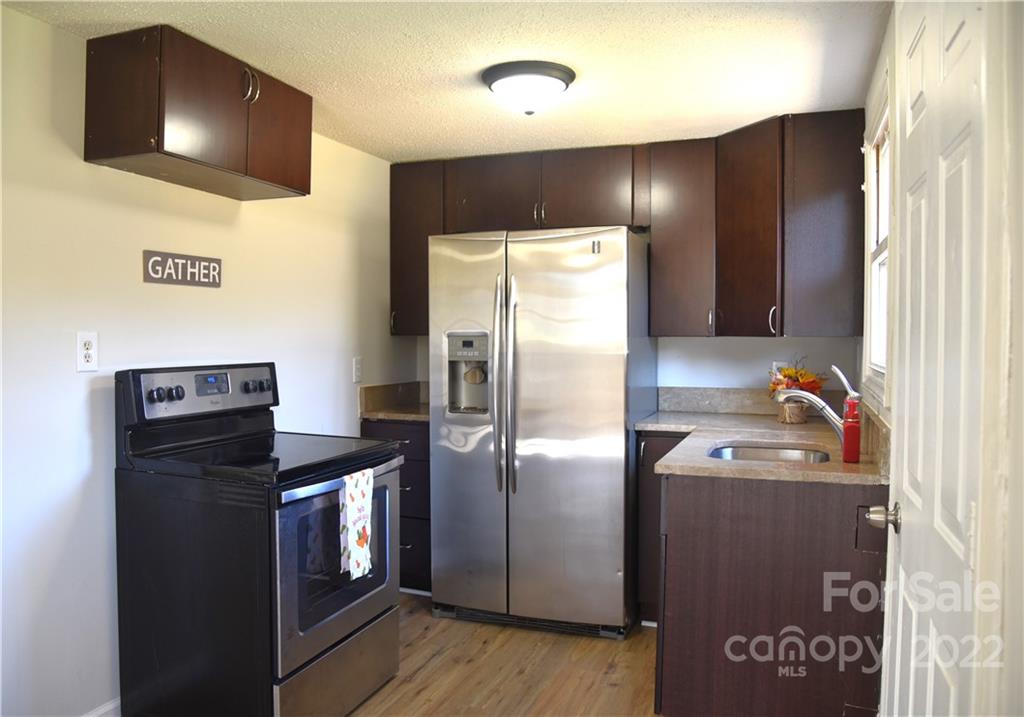 458 Kimmon Road Harmony, NC 28634 - Photo 3 of 23 a kitchen with stainless steel appliances granite countertop a refrigerator and a sink