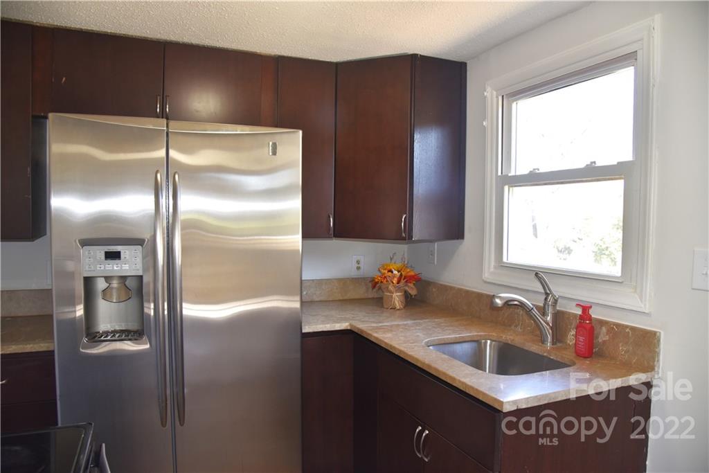 458 Kimmon Road Harmony, NC 28634 - Photo 4 of 23 a kitchen with stainless steel appliances granite countertop a refrigerator and a sink