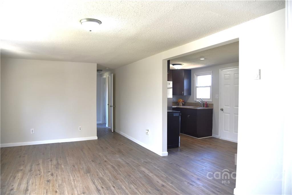 458 Kimmon Road Harmony, NC 28634 - Photo 8 of 23 a view of a hallway with wooden floor