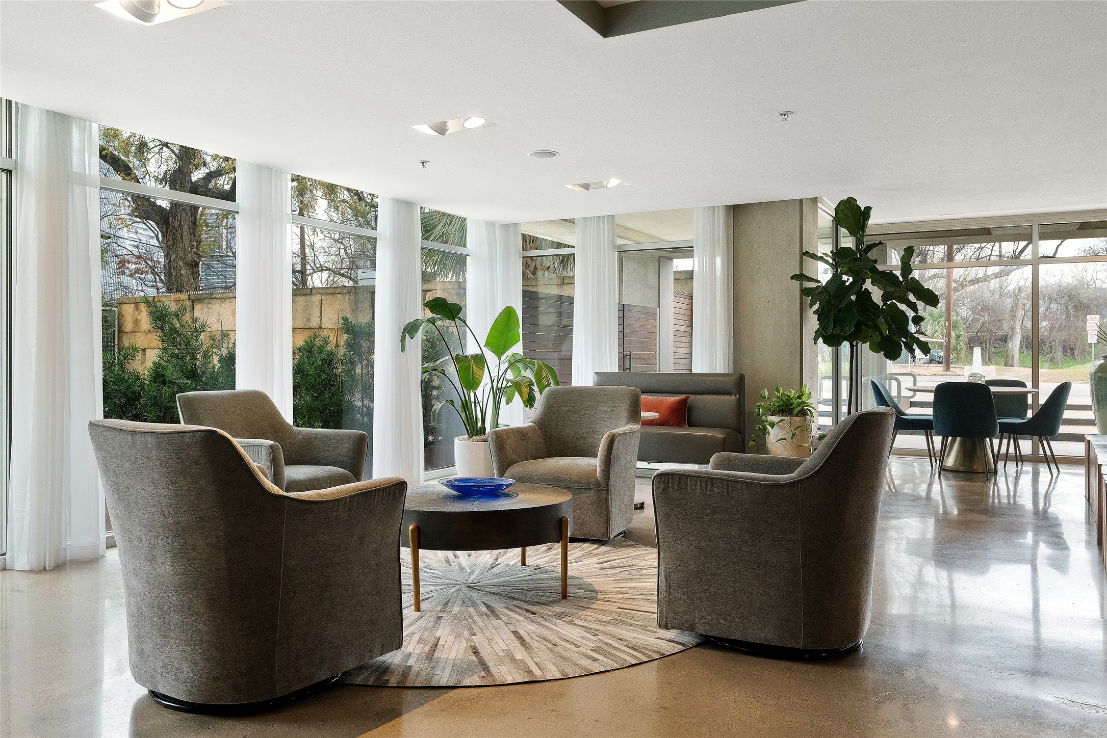 210 Lee Barton Drive, Unit 517 Austin, TX 78704 - Photo 29 of 30 Sophisticated residents' lounge with soaring ceilings, designer furnishings, and an abundance of natural light — ideal for working, relaxing, or entertaining.
