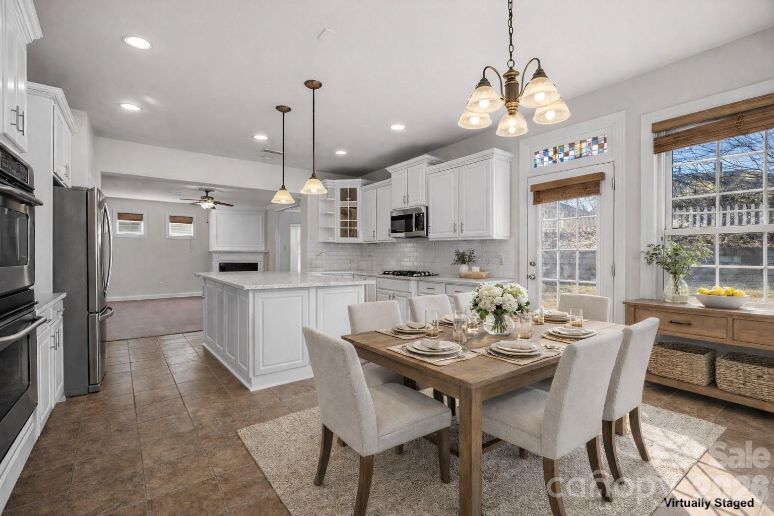 9429 Ridgeforest Drive Charlotte, NC 28277 - Photo 12 of 35 a view of a dining room and a kitchen with a dining table chairs