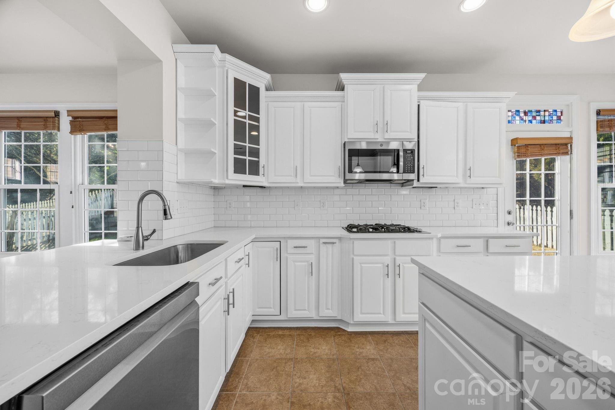 9429 Ridgeforest Drive Charlotte, NC 28277 - Photo 15 of 35 a kitchen with stainless steel appliances granite countertop a sink stove and cabinets