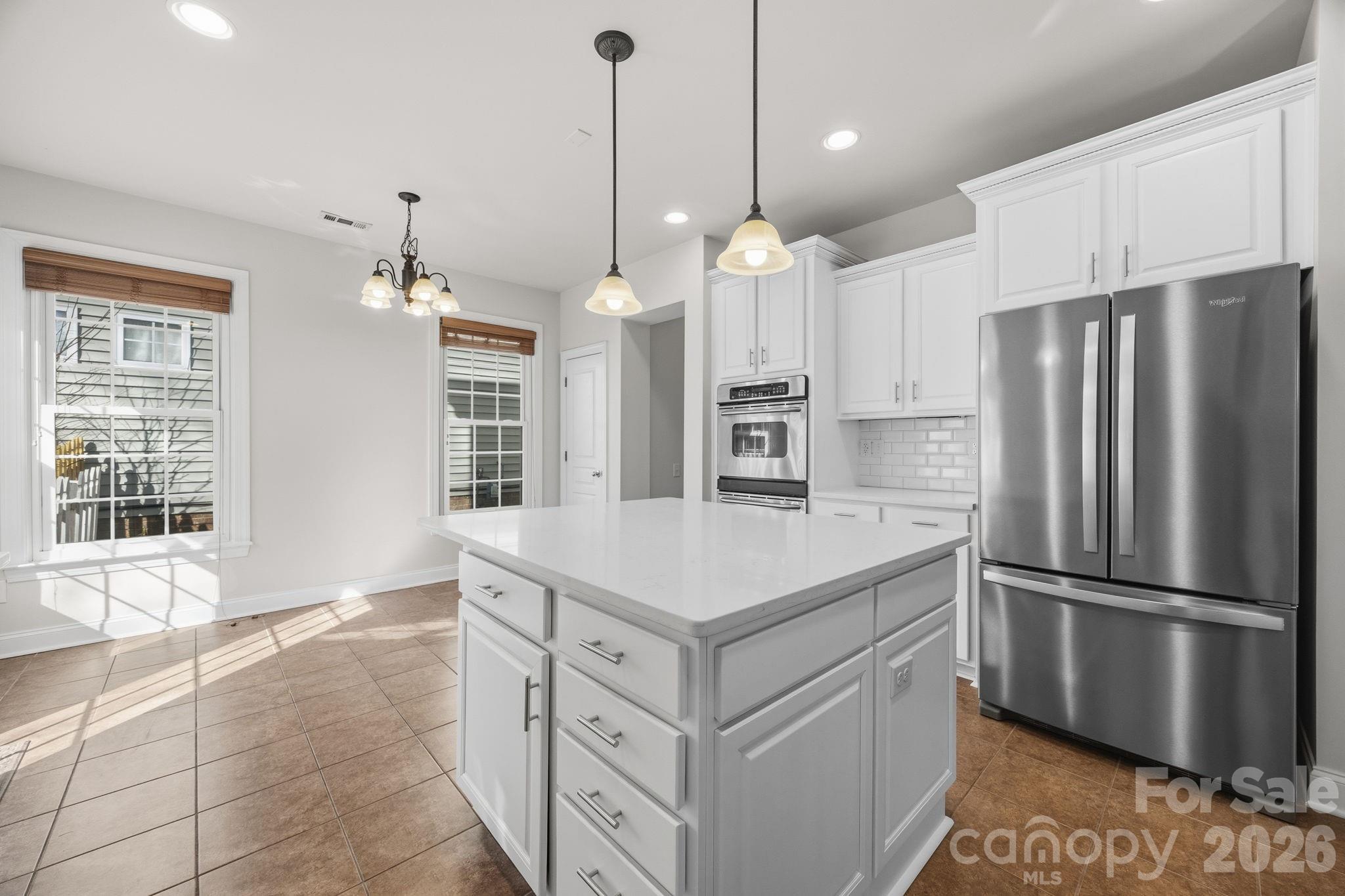 9429 Ridgeforest Drive Charlotte, NC 28277 - Photo 16 of 35 a kitchen with stainless steel appliances granite countertop a refrigerator a sink and a stove