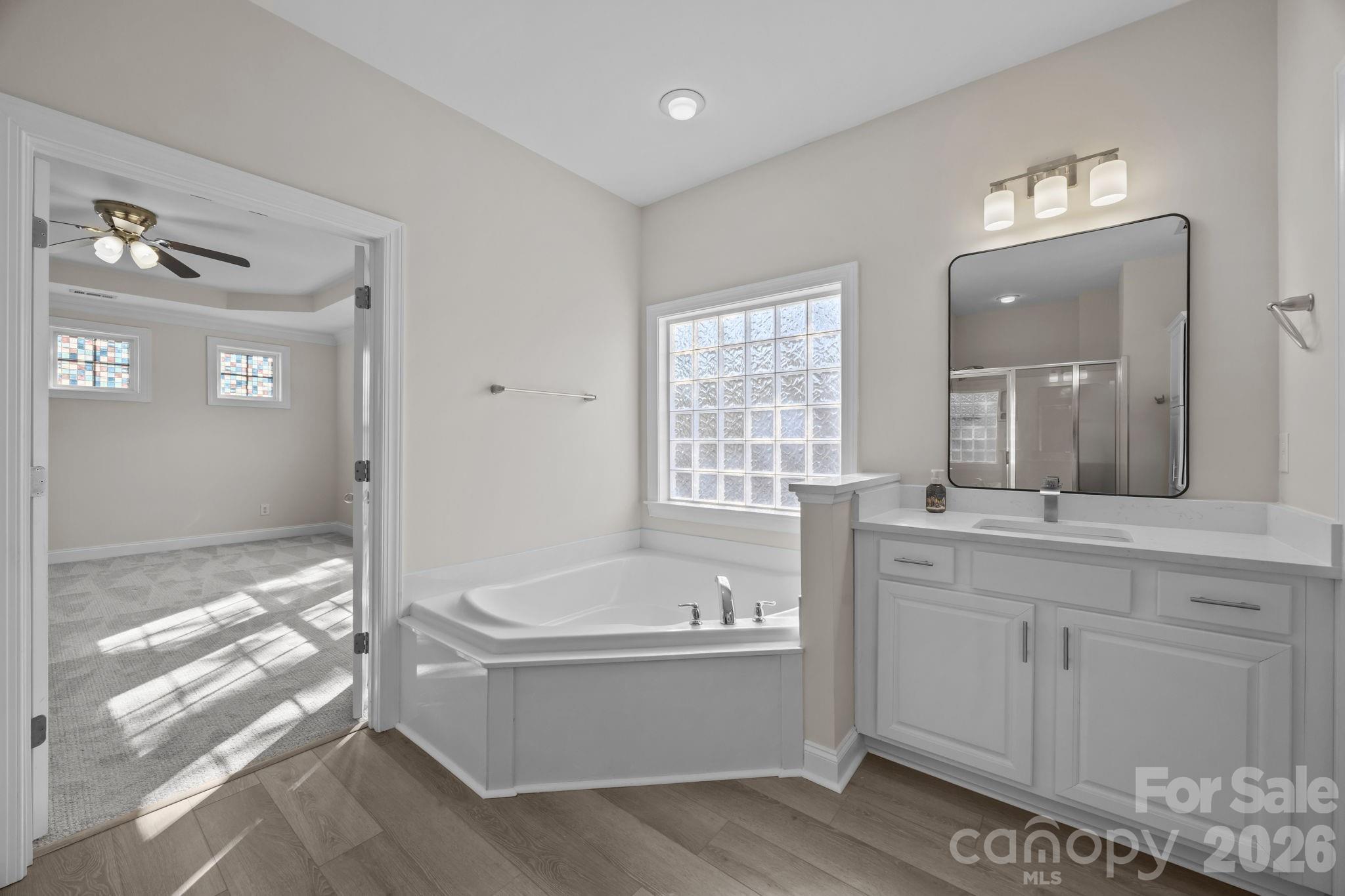 9429 Ridgeforest Drive Charlotte, NC 28277 - Photo 20 of 35 a bathroom with a bathtub and a sink