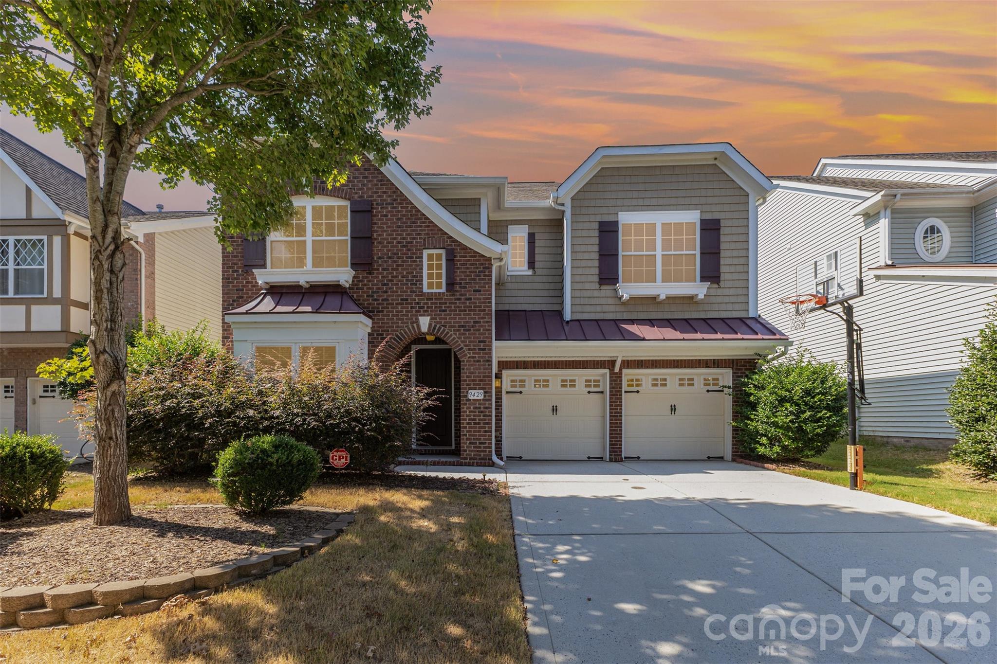 9429 Ridgeforest Drive Charlotte, NC 28277 - Photo 2 of 35 a front view of a house with a yard and garage