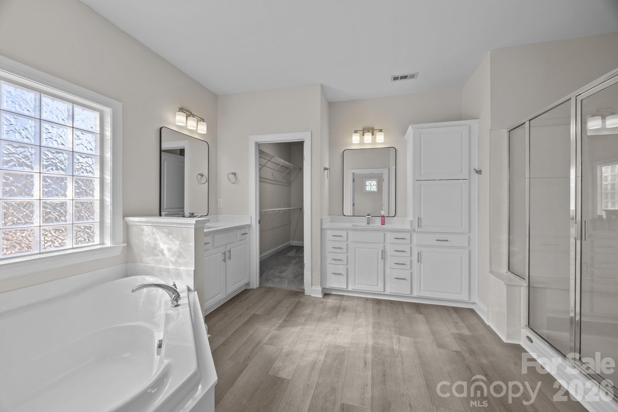 9429 Ridgeforest Drive Charlotte, NC 28277 - Photo 21 of 35 a spacious bathroom with a tub sink and shower