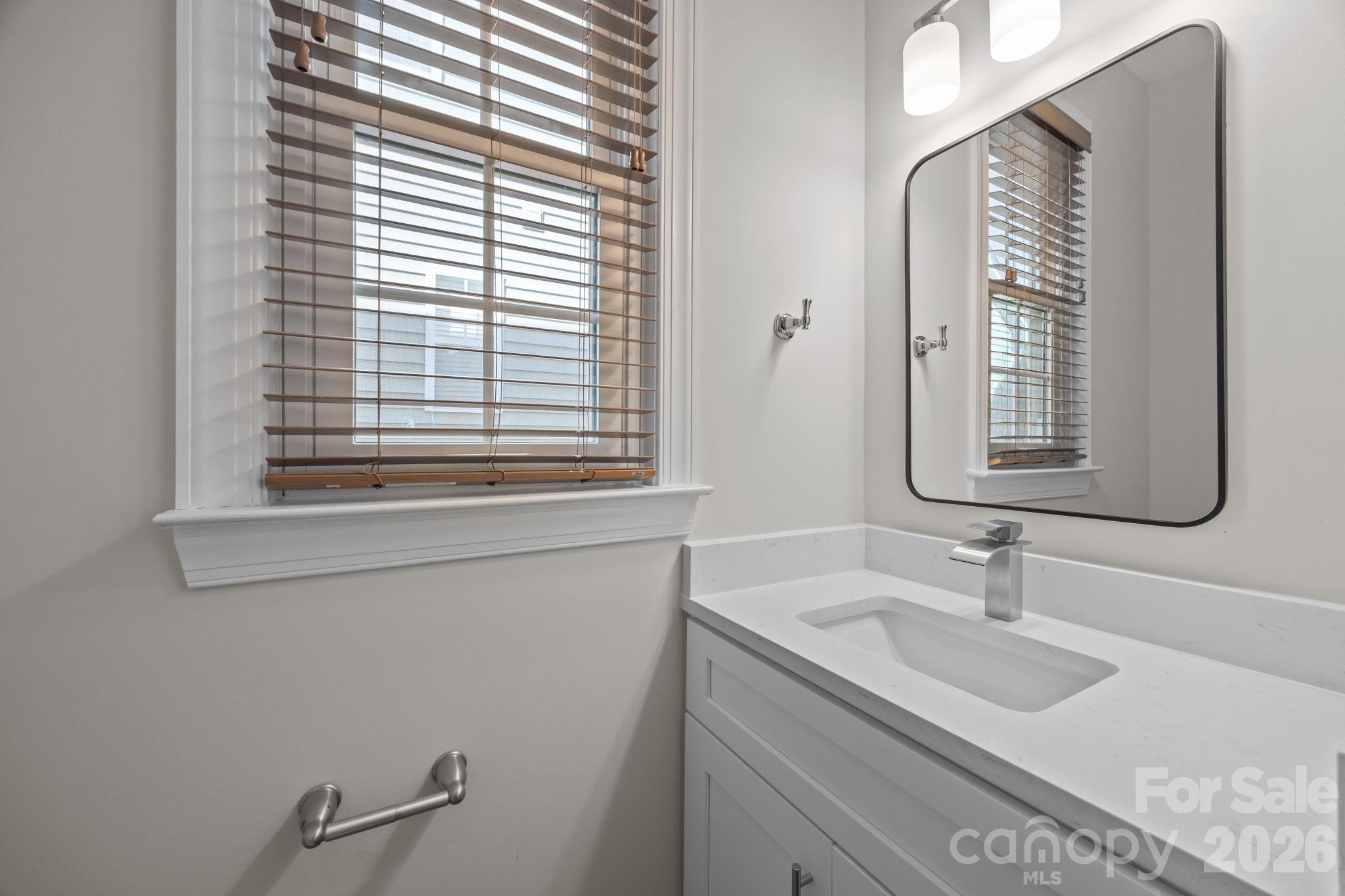 9429 Ridgeforest Drive Charlotte, NC 28277 - Photo 24 of 35 a bathroom with a sink and a mirror