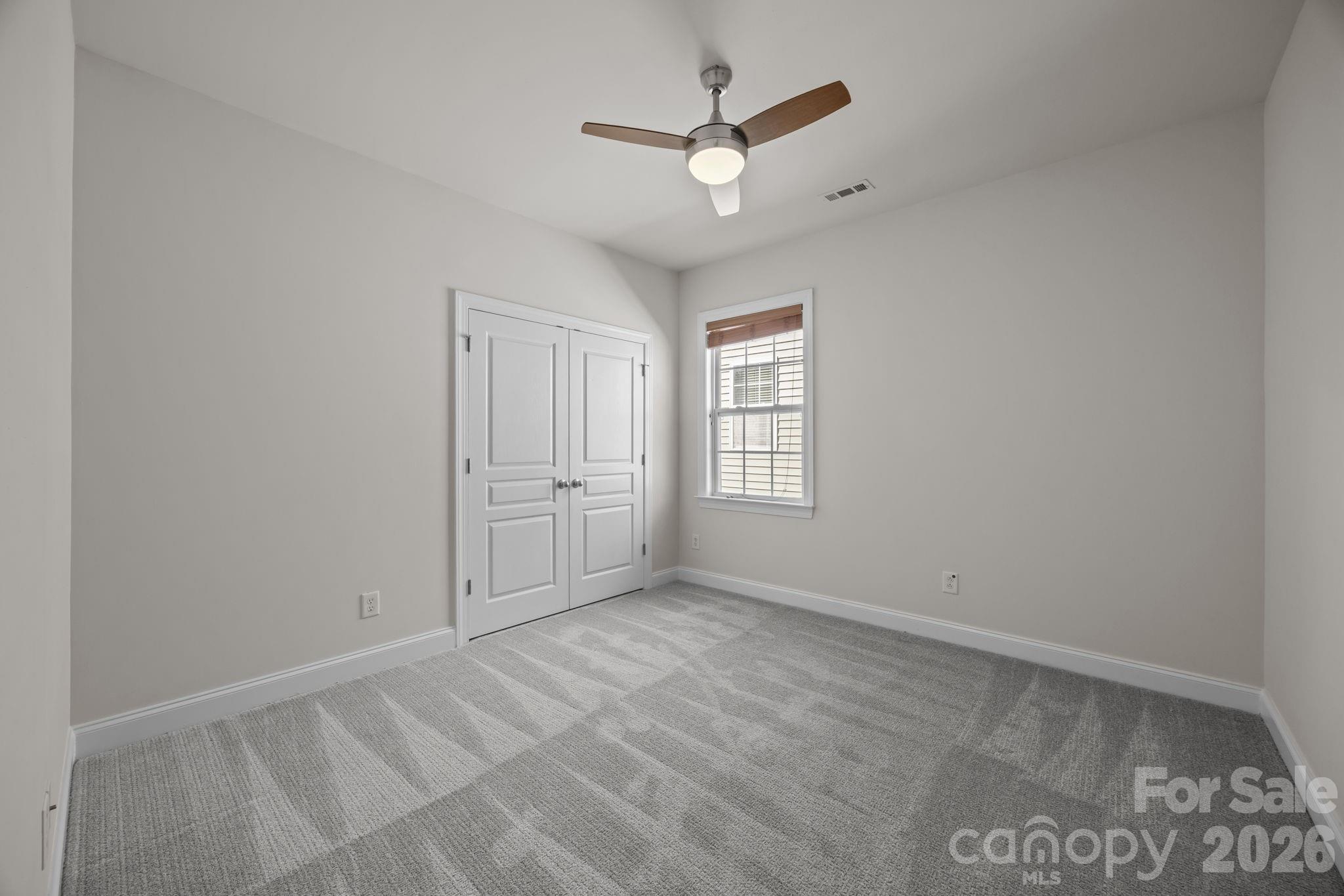 9429 Ridgeforest Drive Charlotte, NC 28277 - Photo 26 of 35 an empty room with windows and fan