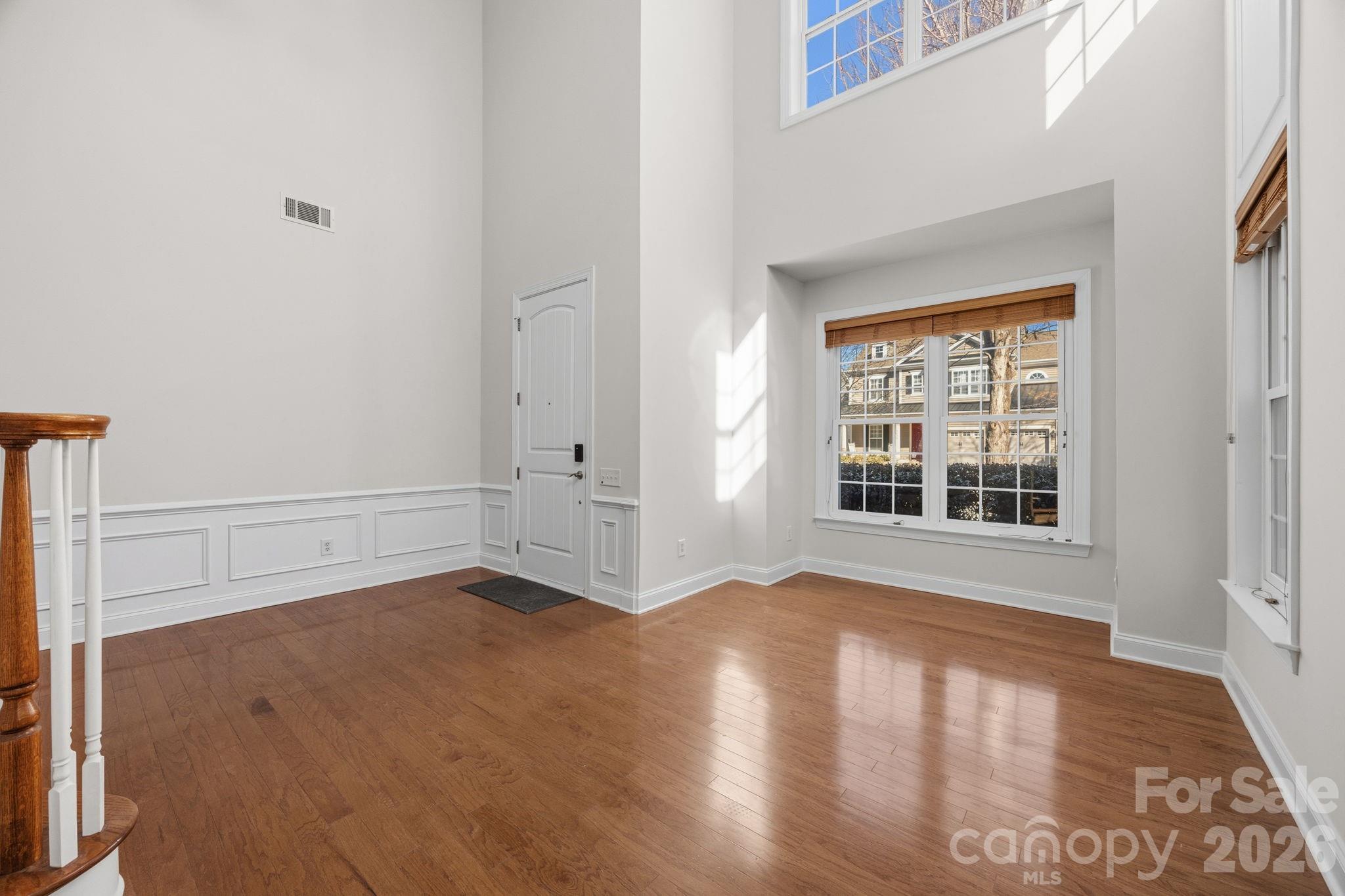 9429 Ridgeforest Drive Charlotte, NC 28277 - Photo 4 of 35 an empty room with wooden floor and windows