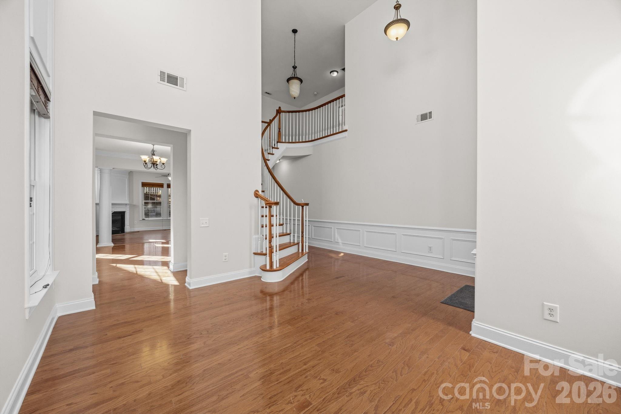 9429 Ridgeforest Drive Charlotte, NC 28277 - Photo 6 of 35 a view of a room with wooden floor and white walls