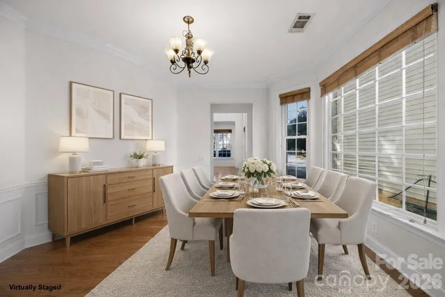 a view of a dining room with furniture and chandelier