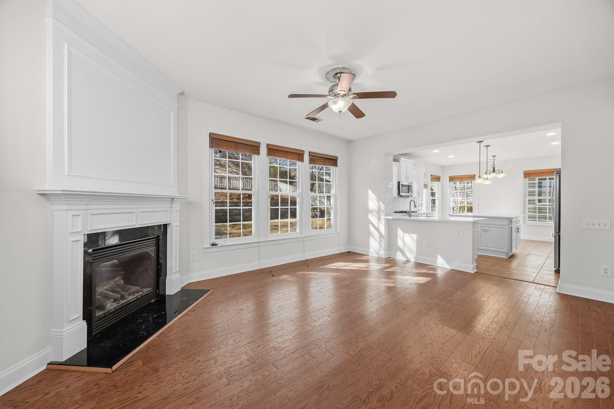 9429 Ridgeforest Drive Charlotte, NC 28277 - Photo 9 of 35 a view of an empty room with kitchen and fireplace