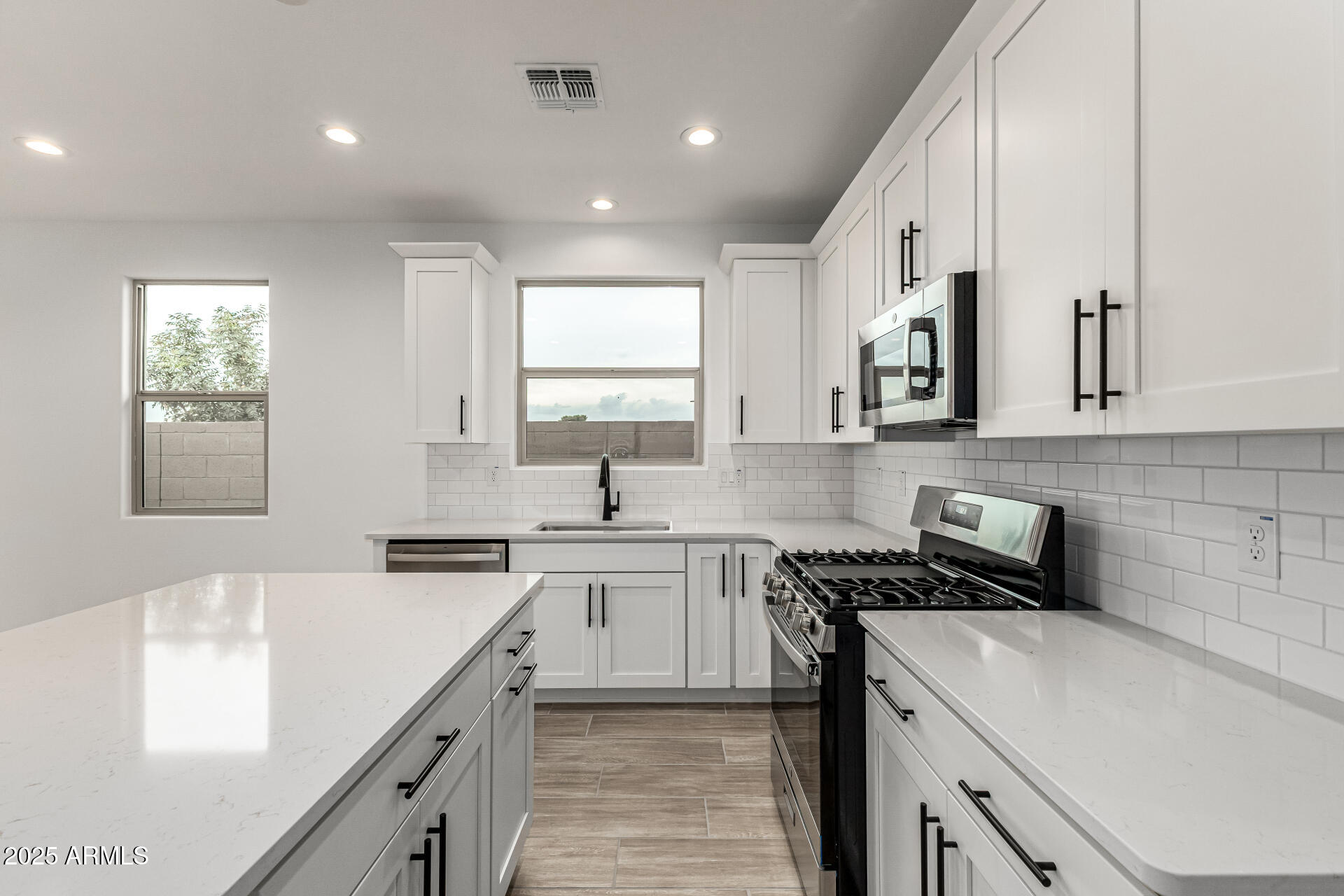 5423 West Royal Palm Road Glendale, AZ 85302 - Photo 5 of 32 a kitchen that has a sink and a stove in it