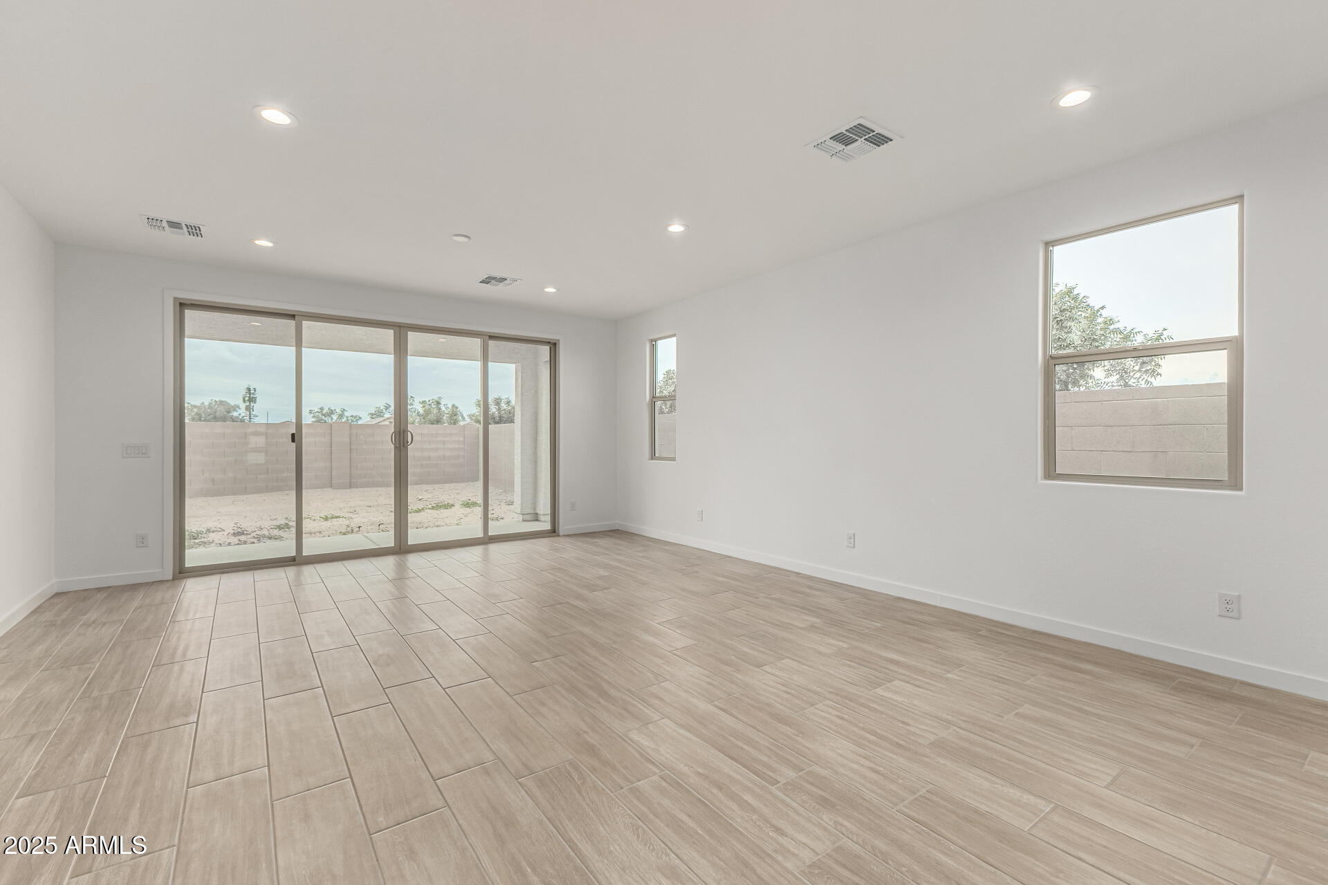 5423 West Royal Palm Road Glendale, AZ 85302 - Photo 7 of 32 an empty room with wooden floor and windows