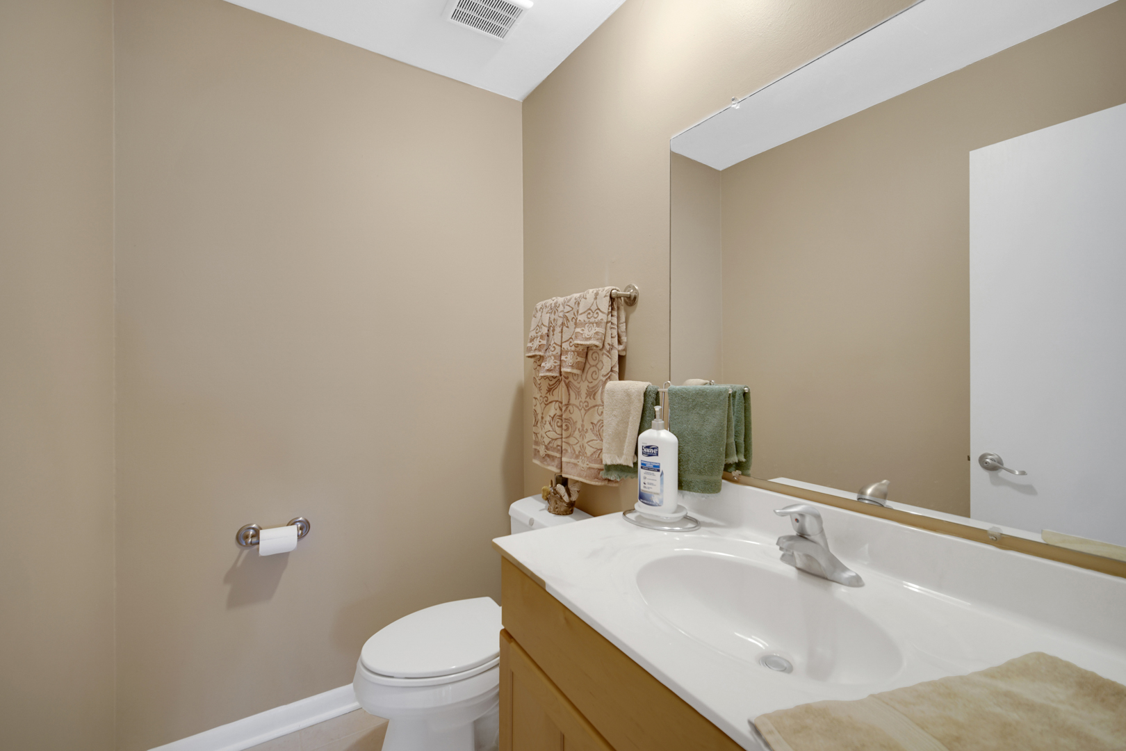 1102 Compton Point Addison, IL 60101 - Photo 11 of 34 a bathroom with a sink vanity mirror and toilet