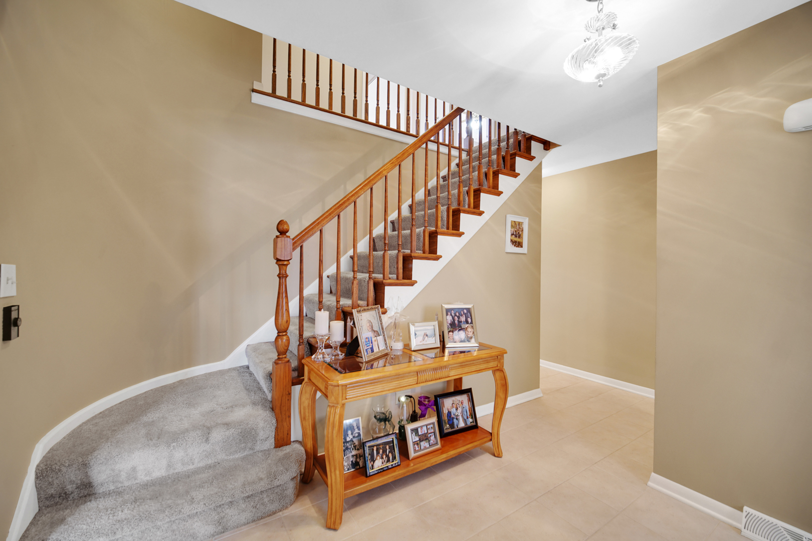 1102 Compton Point Addison, IL 60101 - Photo 3 of 34 a view of staircase with lots of frames on wall and a window