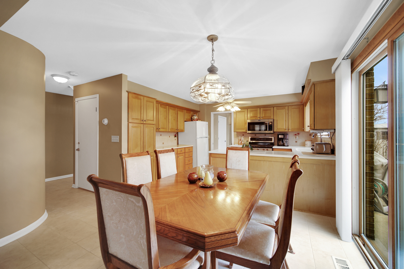 1102 Compton Point Addison, IL 60101 - Photo 7 of 34 a view of a dining room with furniture and a chandelier