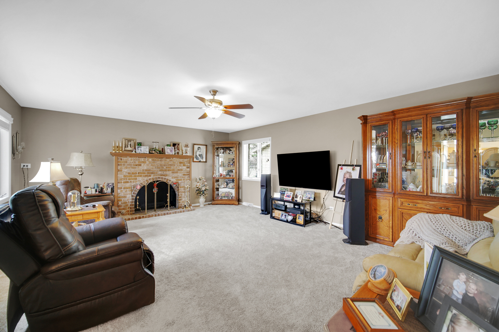 1102 Compton Point Addison, IL 60101 - Photo 8 of 34 a living room with furniture a flat screen tv and a fireplace