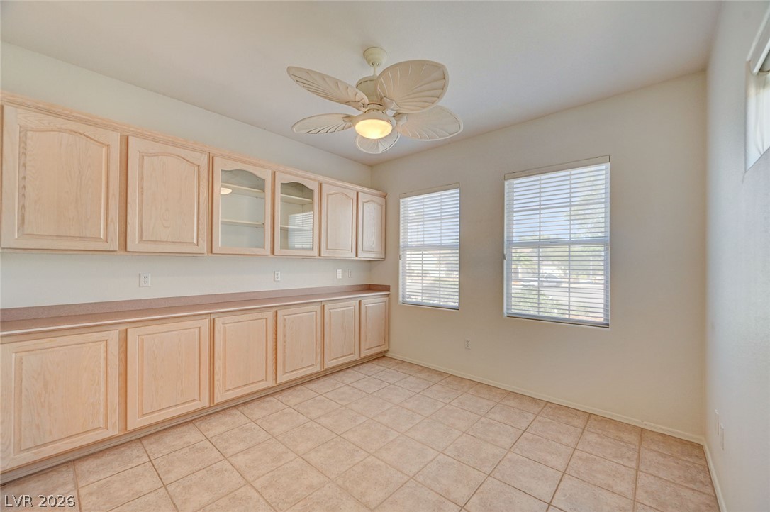 2529 Springville Way Henderson, NV 89052 - Photo 24 of 70 Ample built-in cabinetry and durable tile flooring highlight this versatile multi-use workspace.