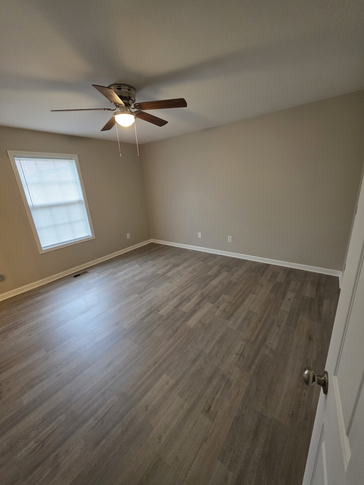 102 Cascade Lane Bell Buckle, TN 37020 - Photo 11 of 21 an empty room with wooden floor ceiling fan and windows