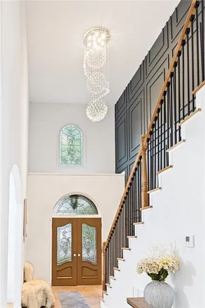 a view of entryway and hall with wooden floor