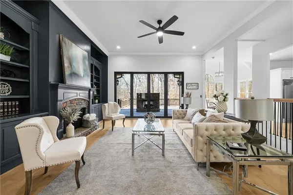 a dining room with furniture a rug and a floor to ceiling window