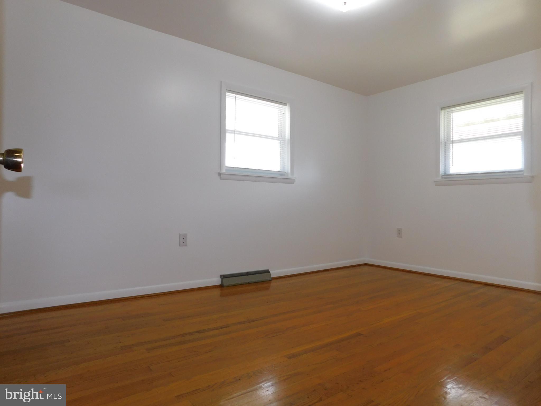 1569 Frank Road Chambersburg, PA 17202 - Photo 13 of 18 an empty room with wooden floor and windows