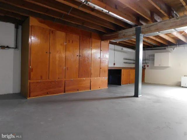 a view of an empty room with a cabinet