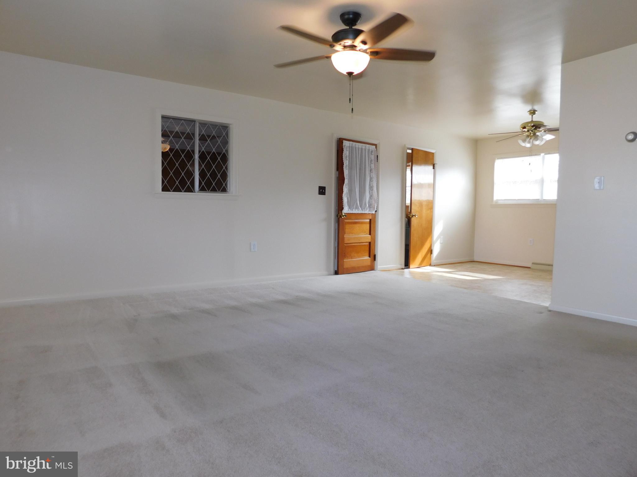 1569 Frank Road Chambersburg, PA 17202 - Photo 5 of 18 en empty room with windows and fan