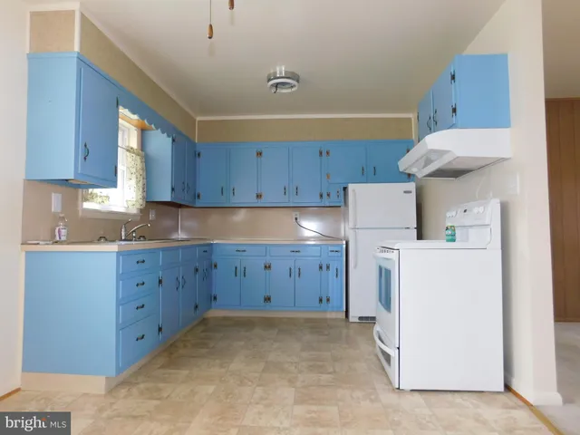 a kitchen with cabinets appliances and a counter space