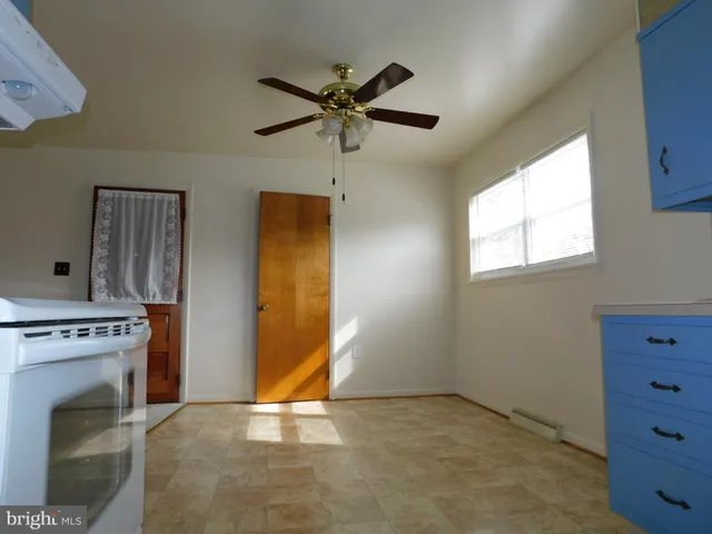 a view of a livingroom with a fireplace and window