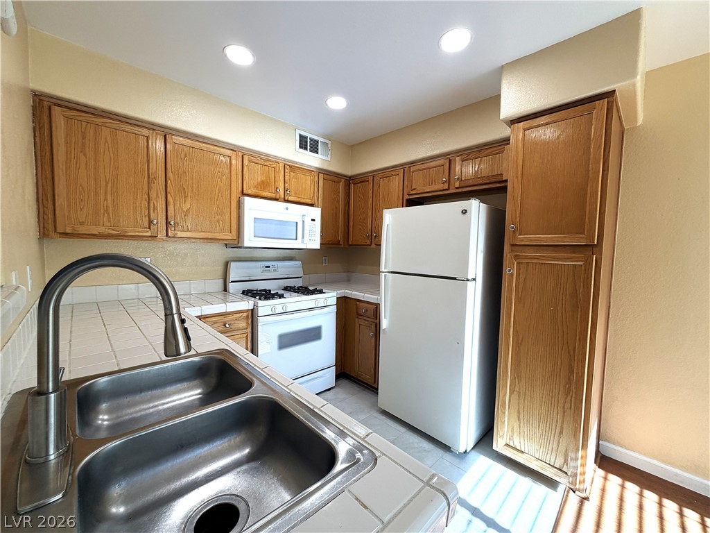 4955 South Lindell Road, Unit 203 Las Vegas, NV 89118 - Photo 2 of 31 Functional kitchen with ample cabinetry and efficient appliance layout for daily use.