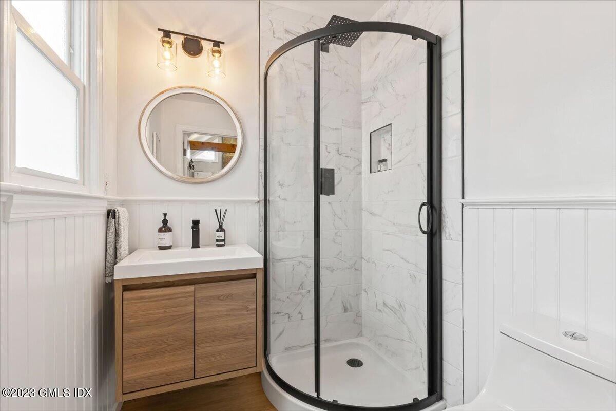5 Sunshine Avenue Riverside, CT 06878 - Photo 18 of 35 a bathroom with a sink a vanity and a mirror