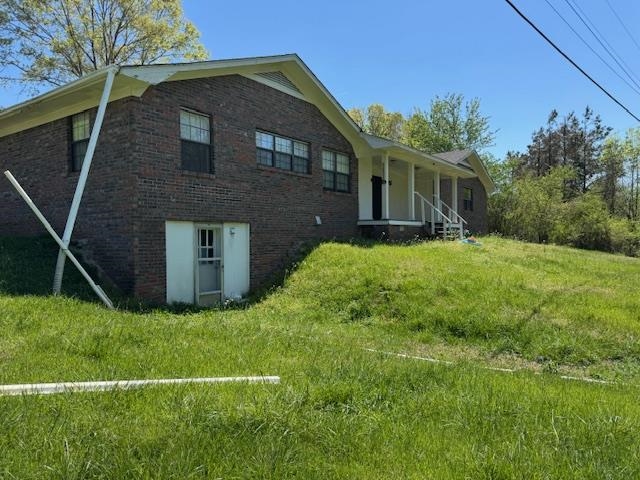 1150 Pocahontas Road Pocahontas, TN 38061 - Photo 28 of 33 a brick house with a yard