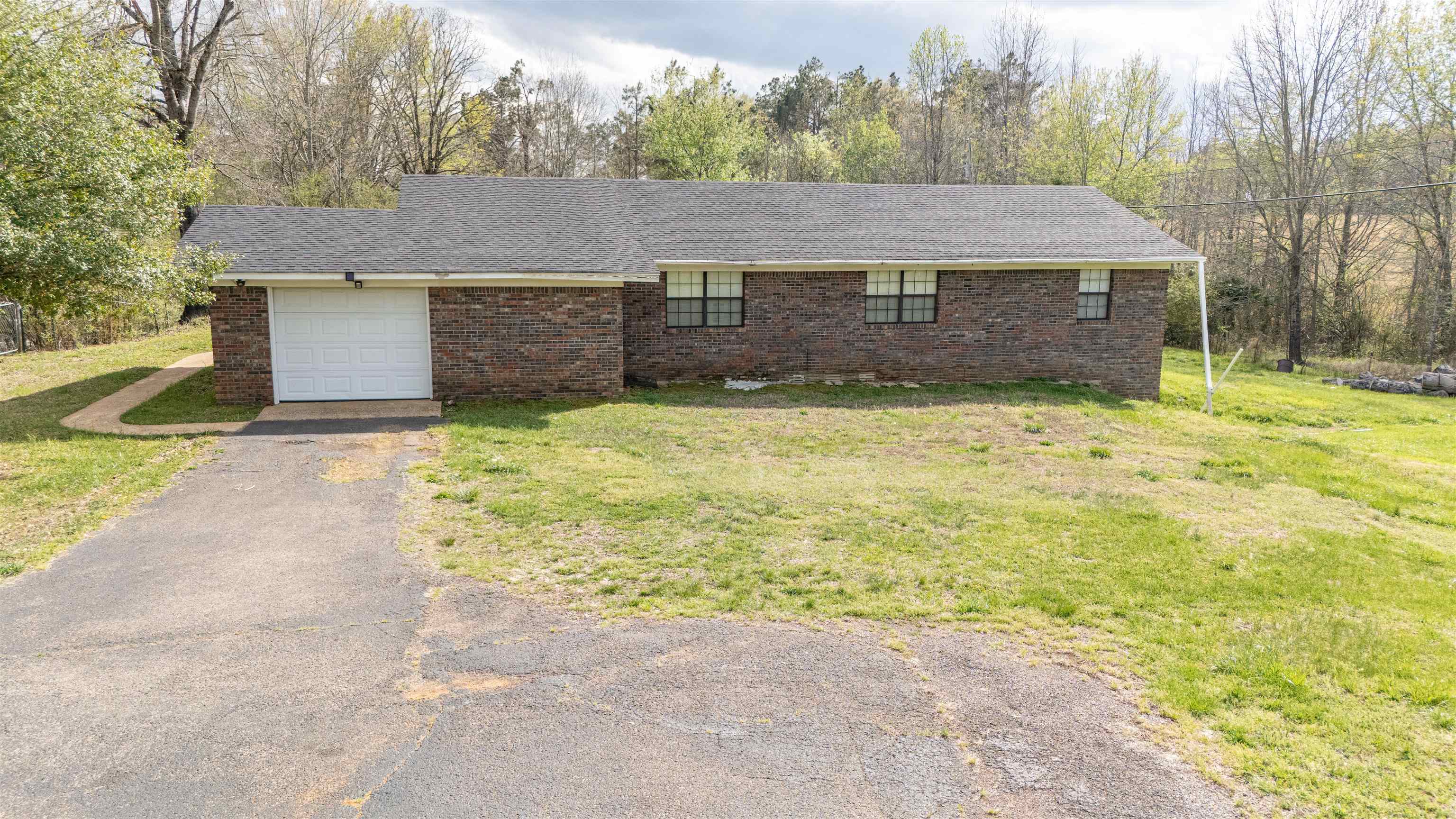 1150 Pocahontas Road Pocahontas, TN 38061 - Photo 3 of 33 a front view of a house with a yard and garage
