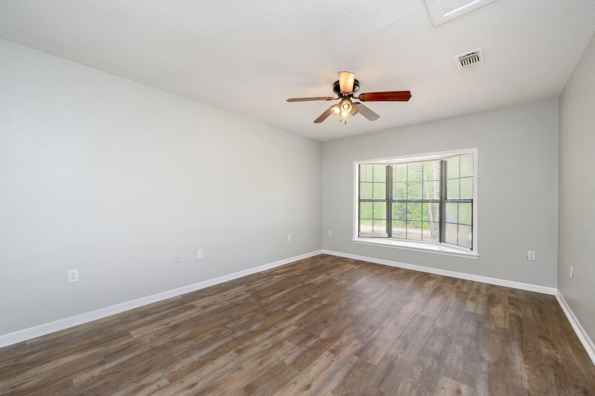 3970 Indian Mound Road Crestview, FL 32539 - Photo 11 of 33 a view of a room with wooden floor and windows