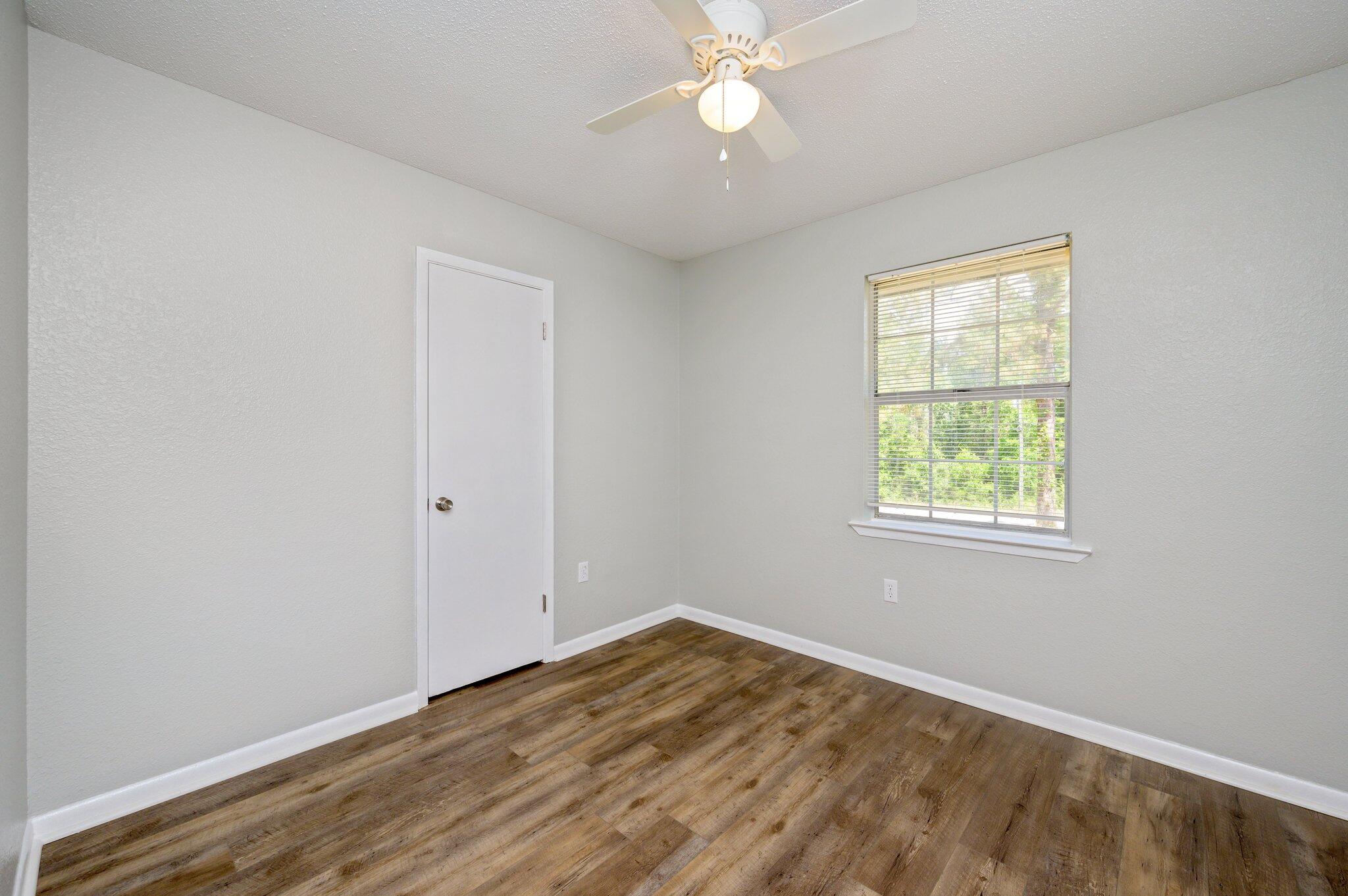 3970 Indian Mound Road Crestview, FL 32539 - Photo 15 of 33 a view of empty room with wooden floor and fan