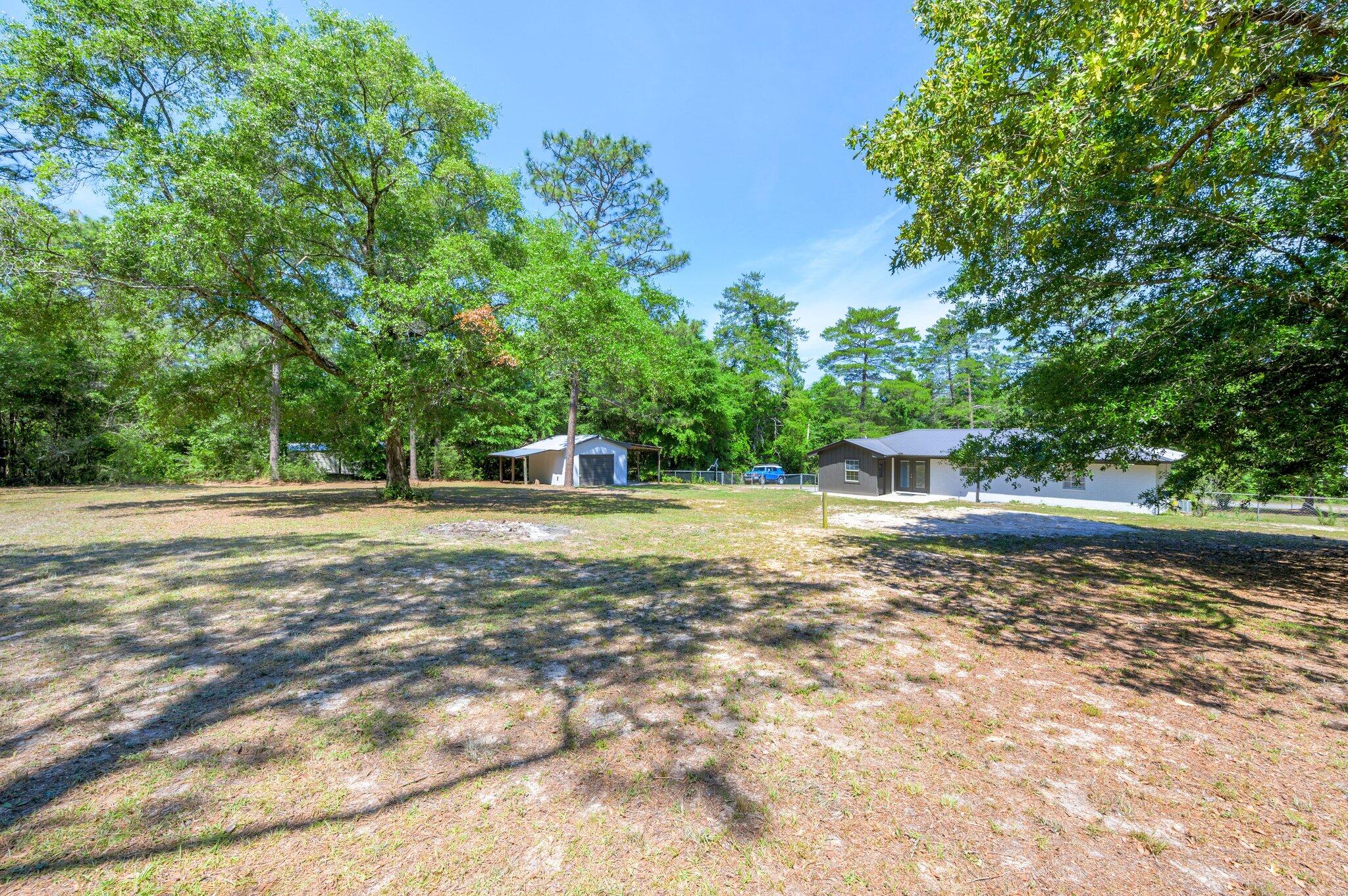 3970 Indian Mound Road Crestview, FL 32539 - Photo 32 of 33 a view of green field with trees in the background