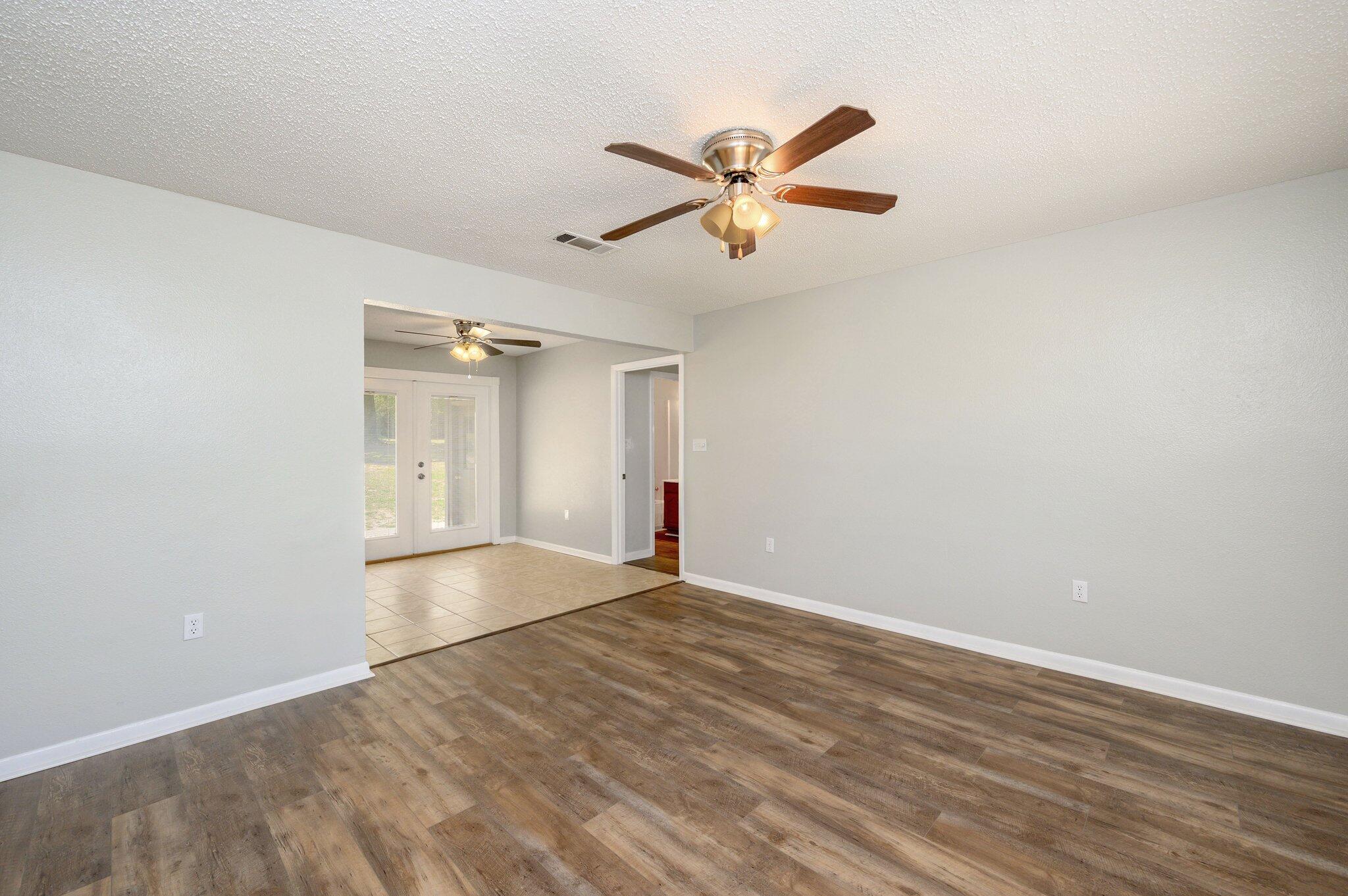 3970 Indian Mound Road Crestview, FL 32539 - Photo 5 of 33 a view of empty room with wooden floor and ceiling fan